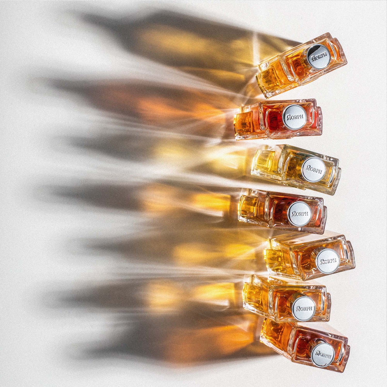 Row of bottles of morph perfume with the cap visible
